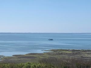 a boat in the middle of a large body of water at 澎湖海景民宿 島嶼時光 Island Time Homestay in Magong