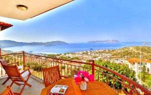 a balcony with a table with flowers on it at Kaş Homes 5 in Kas