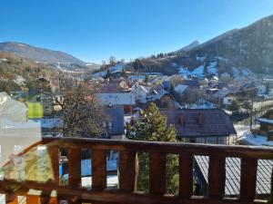 a view from the balcony of a town in the snow at Penzión Malá Fatra u Ďurka -Terchová in Žilina
