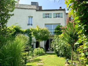 an old house with a garden in front of it at Beautiful large stylish villa centrally located in Pons in Pons