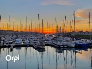 a group of boats docked in a marina at sunset at REF 020 Maison 5 chambres proche plage et Port du Crouesty à louer pour les vacances in Arzon