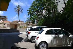 a row of cars parked in a parking lot at Hotel Mediterraneo in Cefalù