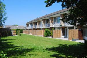 a building with a lawn in front of it at Appartement Walvis nr. 16 in Vrouwenpolder