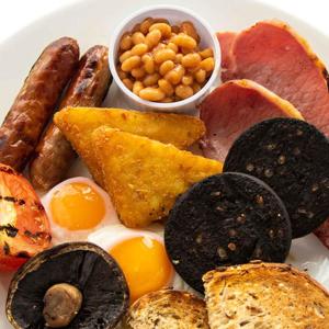 a plate of food with eggs sausage bread and beans at Green Lodge, Wirral by Marston's Inns in Hoylake