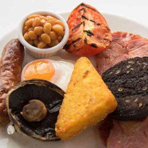 a plate of food with eggs mushrooms and other foods at Green Lodge, Wirral by Marston's Inns in Hoylake
