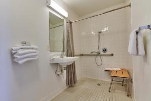 a white bathroom with a sink and a mirror at Motel 6-Irving, TX - Dallas in Irving
