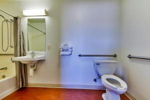 a bathroom with a toilet and a sink at Motel 6-Irving, TX - Dallas in Irving