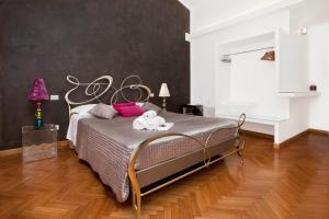 a bedroom with a large bed in a room at Town House Fontana Di Trevi in Rome