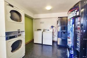 a laundry room with a washer and dryer at Motel 6-Irving, TX - Dallas in Irving