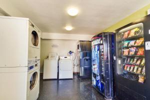 a laundry room with a washer and dryer at Motel 6-Irving, TX - Dallas in Irving