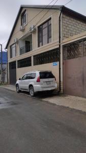 a white car parked in front of a house at Guest house U Morya in Derbent