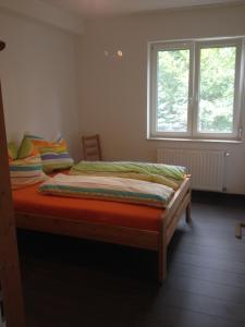 a bed in a room with a window at Platán apartman in Budapest