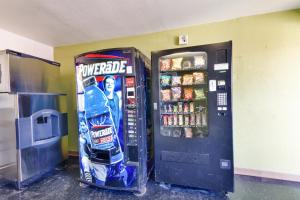a soda machine and a vending machine with drinks at Motel 6-Irving, TX - Dallas in Irving