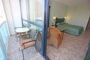 a view of a room with a bed and a table at KAKTUS Hotel Kaktus Albir in Albir