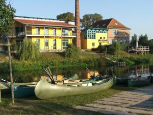 a group of boats on the water in front of a building at Ferienwohnung B Gästehaus Mühlenstein in Bad Sülze