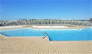a large swimming pool with a fence around it at GOELETTES 311 in Saint-Cyprien