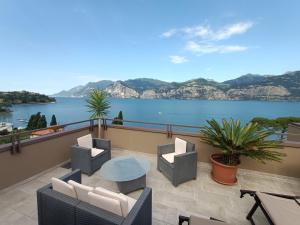 a balcony with a view of the water at Hotel Antonella in Malcesine