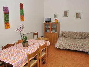 a living room with a table and a couch at Residence Filanda in Ledro