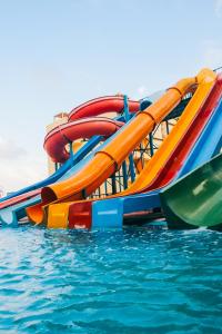 a colorful water slide on a boat in the water at Retal View North Coast Aqua Park in El Alamein