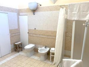 a bathroom with a toilet and a sink at Palazzo Barba in Gallipoli +25 photos