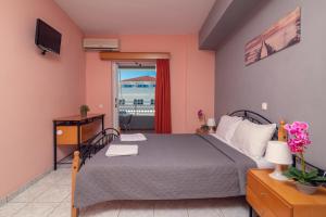 a bedroom with a bed and a balcony at Avouris 2 Bedroom Apartment & Studios in Plános
