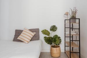 A bed or beds in a room at Apartamentos Espai Progres by Be Barcelona