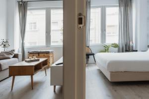 A bed or beds in a room at Apartamentos Espai Progres by Be Barcelona