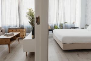 A bed or beds in a room at Apartamentos Espai Progres by Be Barcelona