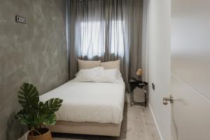 A bed or beds in a room at Apartamentos Espai Progres by Be Barcelona
