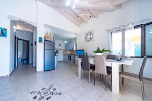 a kitchen and dining room with a table and chairs at Villa Tiziana&Alessia in Castiadas