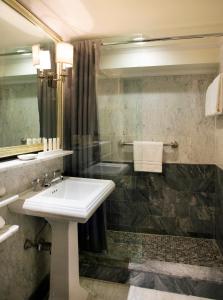 a bathroom with a sink and a shower at The Eliot Hotel in Boston