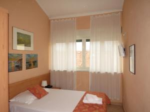 Postel nebo postele na pokoji v ubytování Hotel Massimo