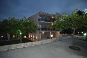 a building with a tree in front of it at night at Panorama Siviris in Siviri