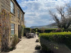 a patio with tables and chairs next to a building at The Farmhouse in Whitby