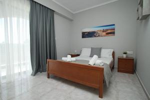 a bedroom with a bed and a large window at Panorama Siviris in Siviri