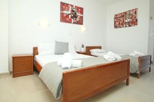 a bedroom with two beds with white towels on them at Panorama Siviris in Siviri