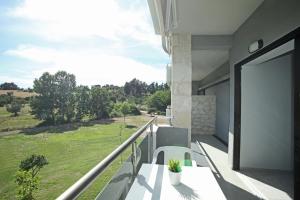 a balcony with a view of a green field at Panorama Siviris in Siviri