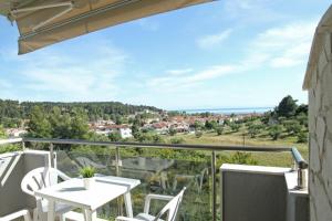 a view from the balcony of a house with a table and chairs at Panorama Siviris in Siviri