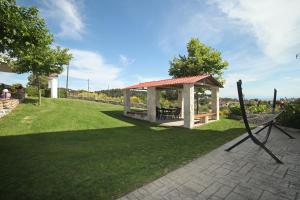 a gazebo with a bench in a yard at Panorama Siviris in Siviri