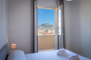 a room with a bed and a window with a view at Palermo Blu - Multi Suite in Palermo