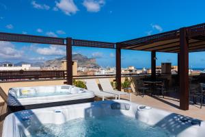 a hot tub on a roof with a view at Solemar Sicilia - Multi Suite in Palermo