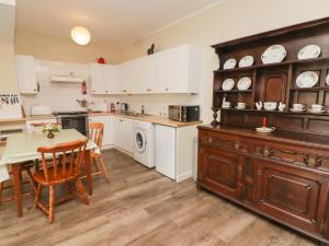 a kitchen with a table and a dining room at The School Room in Kington