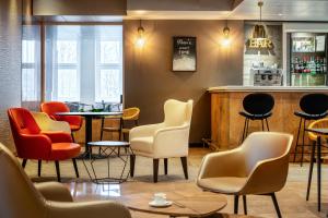 a bar with chairs and a counter in a room at ibis Paris porte de Bercy in Charenton-le-Pont +13 photos
