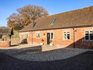 a red brick building with a black roof at The Milking Parlour in Craven Arms