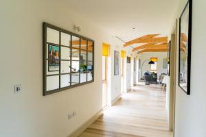 un couloir d'une maison avec des fenêtres et du parquet dans l'établissement Willow Cottage at Gravel Farm, à Stretham