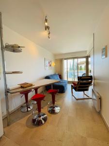 a living room with a table and some red stools at Floriana in Cannes