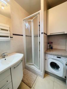 a bathroom with a washing machine and a sink at Floriana in Cannes