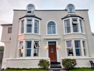 a large white house with a brown door at Westcliff in Seascale