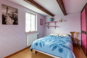 a bedroom with a bed with a blue blanket at L'Audacieuse in Eckbolsheim