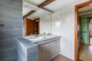 a bathroom with two sinks and a mirror at L'Audacieuse in Eckbolsheim